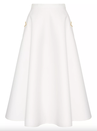 a white Valentino skirt in front of a plain backdrop