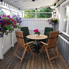 a table and chairs on a porch