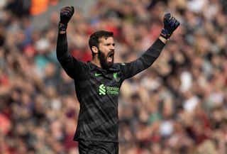 Alisson Becker celebrates a goal for Liverpool against Tottenham in May 2024.