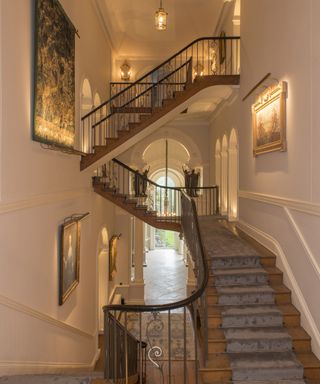 A staircase lighting idea by Rebecca Hughes Interiors with light sources used across multiple levels in an Oxford-based home