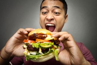 A man eating a burger. 