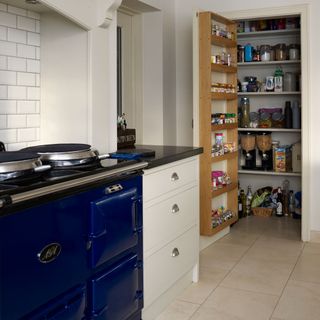 kitchen pantry with white tiled flooring and kitchen shelves
