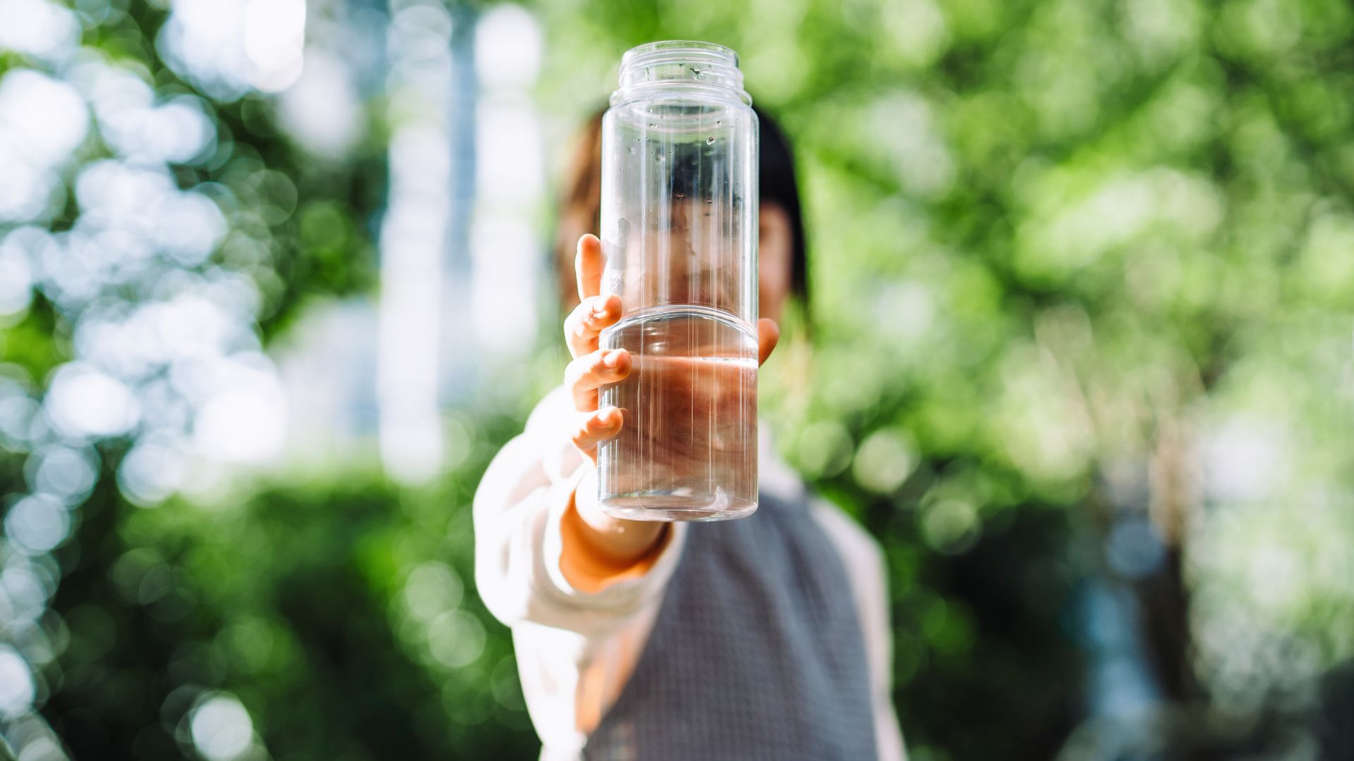 Woman holding up a bottle of water