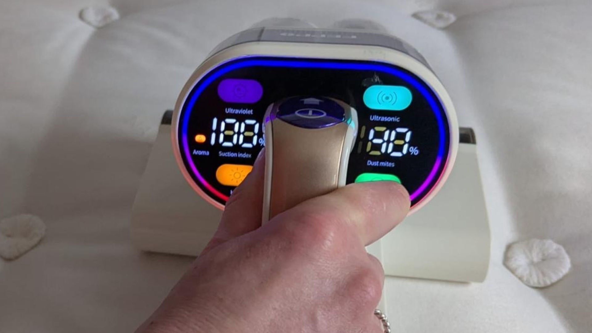 Our tester uses the white FEPPO Mattress Vacuum Cleaner to remove fine dust and particles from inside her mattress and pillow