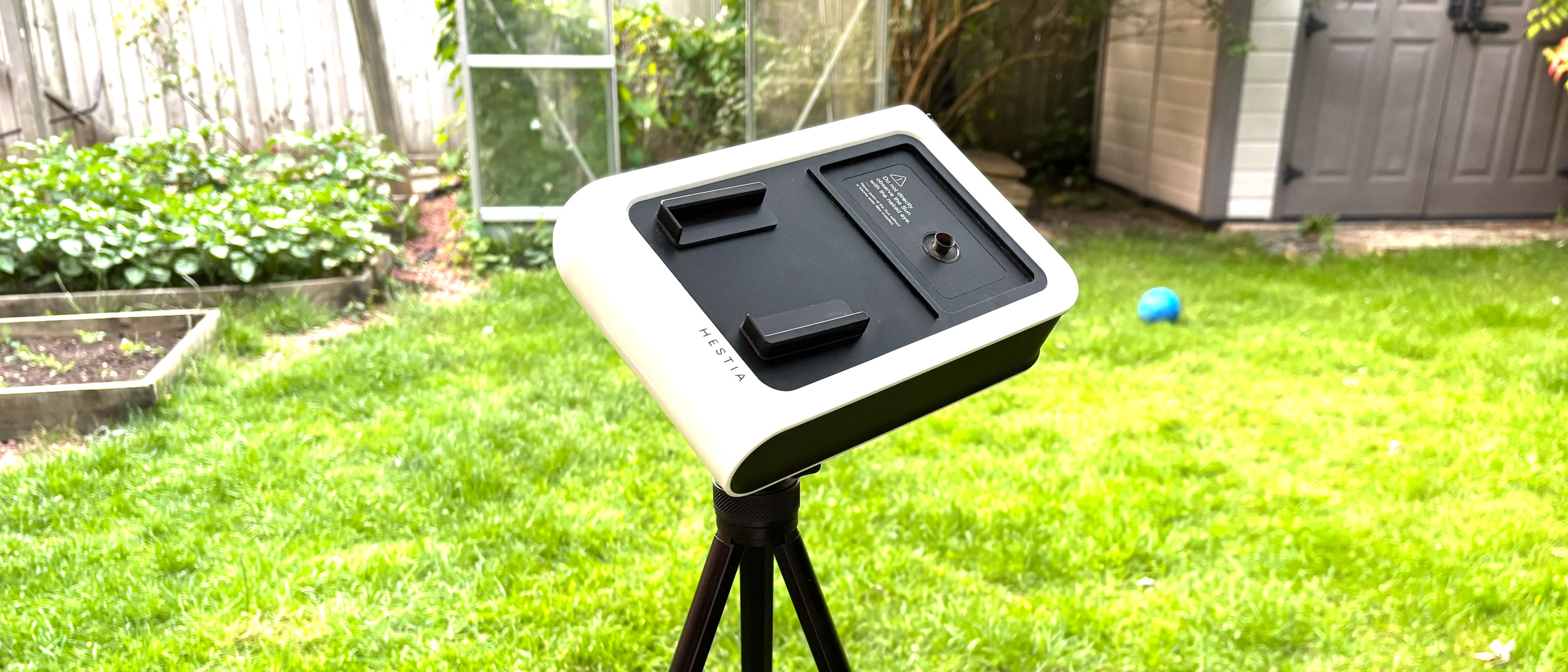 The Vaonis Hestia on a tripod in a back garden.