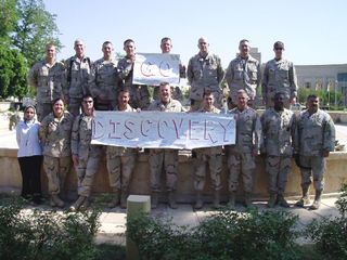 Members of the U.S. Army's Third Infantry Division Governorate Support Team stationed in Baghdad, Iraq, are shown holding the