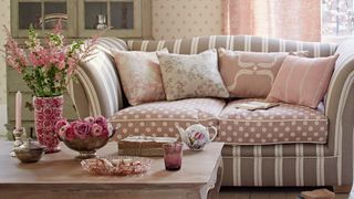 picture of patterned sofa with stripes and floral design in pink and beige room