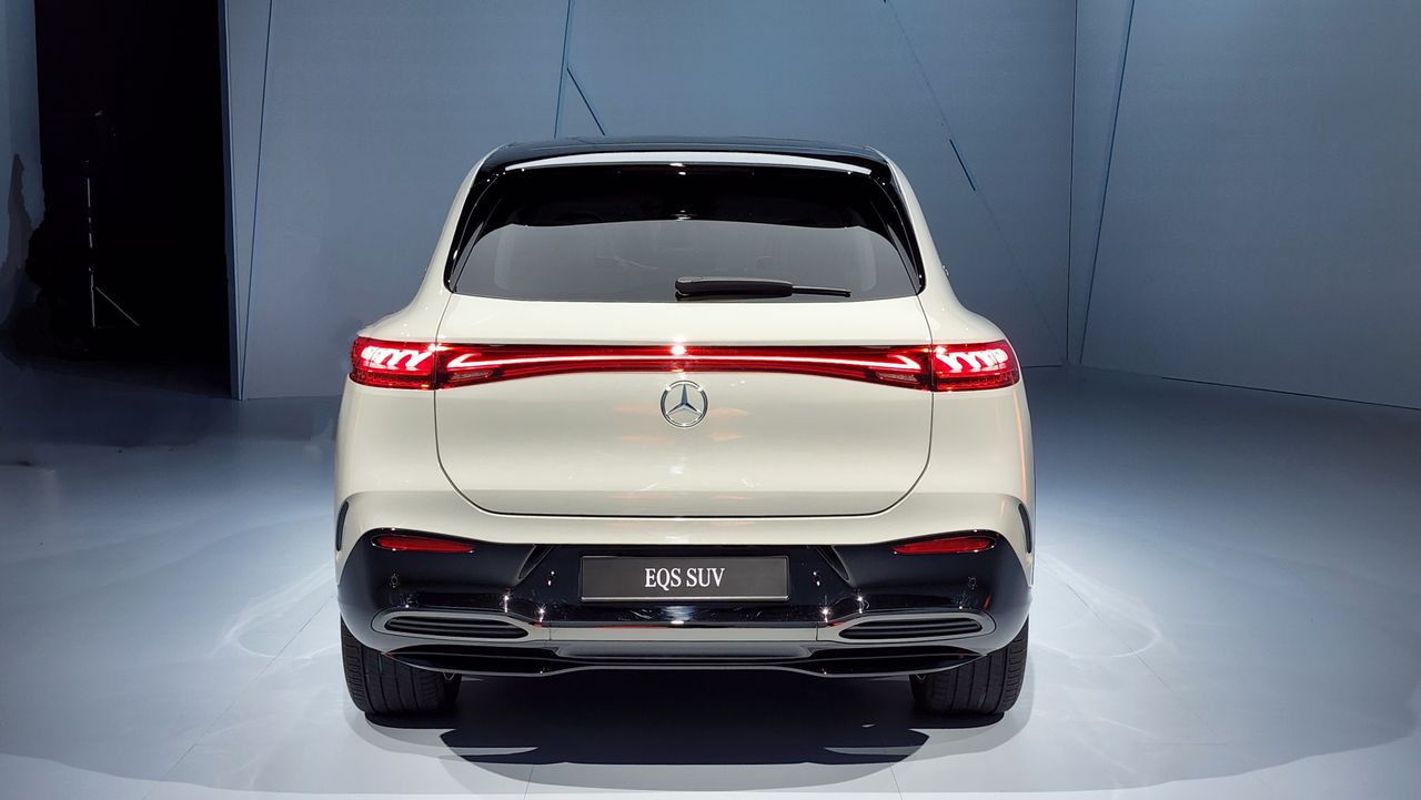 Rear view of a white EQS SUV parked in a studio