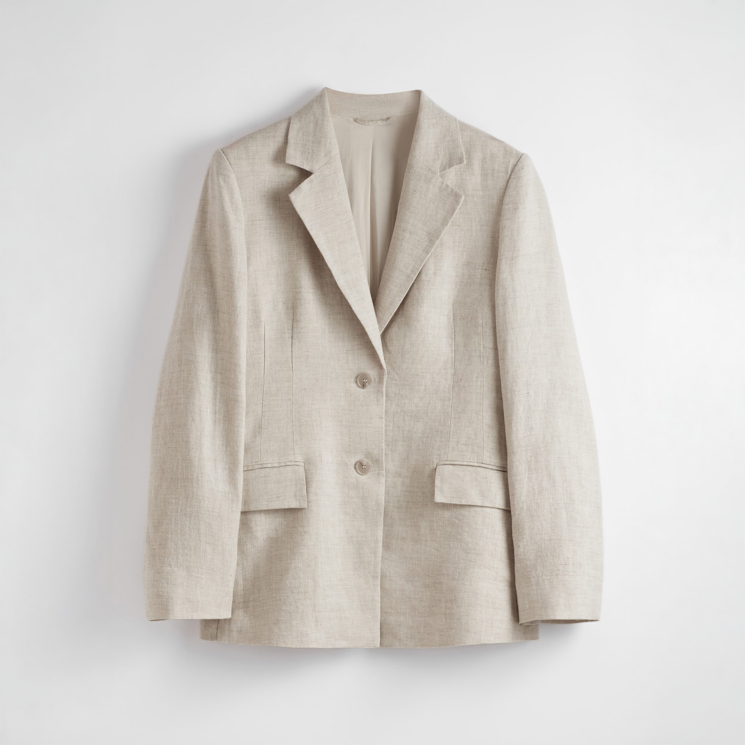 A cutout of a linen blazer from &OtherStories against a white background
