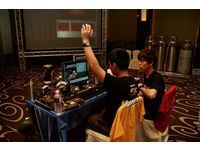 The Hong Kong team shows the working staff the completion of item Super Pi by raising their hands.