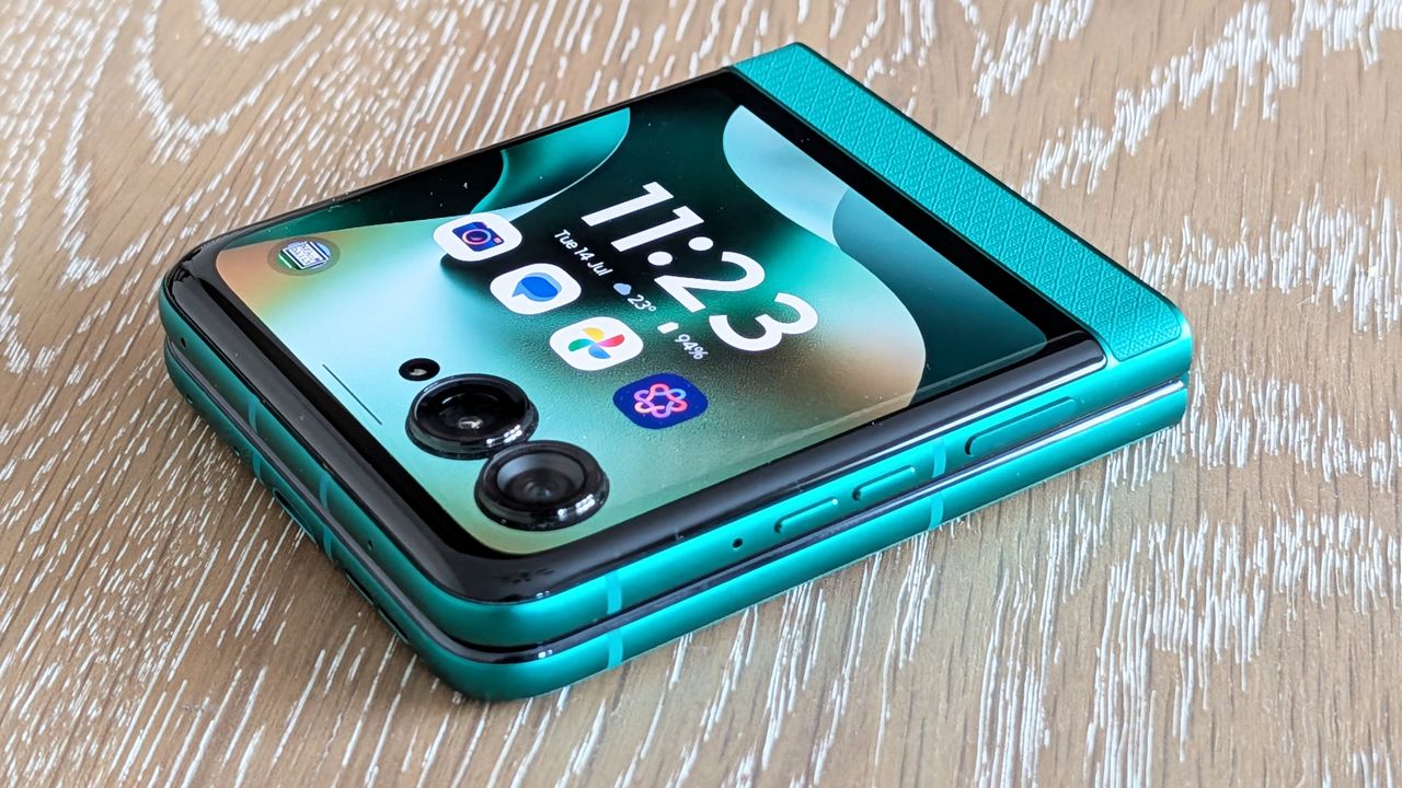 Motorola Razr 2026 in blue, being held in the hand
