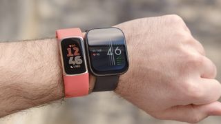 A Fitbit Charge 6 shown on a wrist next to the Amazfit Bip 5.
