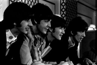 A black and white picture of all four members of The Beatles