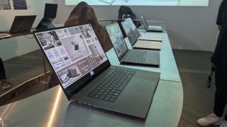 A photograph of several new Asus Zenbook laptops on display at an event.