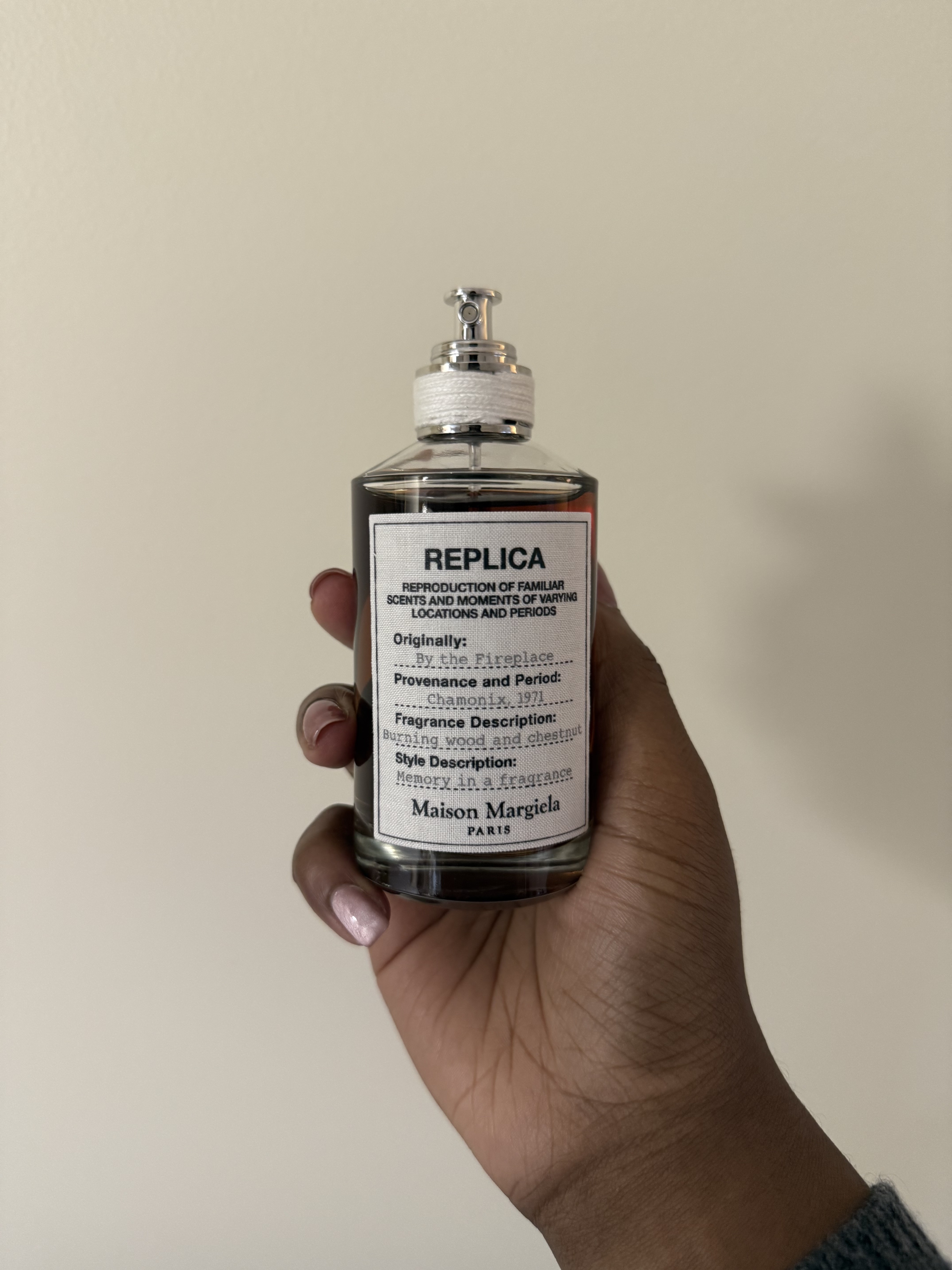Associate beauty editor Maya Thomas holds Maison Margiela Replica By the Fireplace Eau de Toilette.