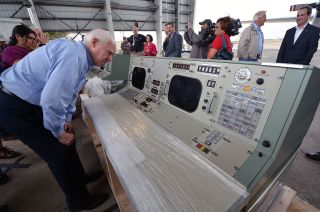 Apollo-era Flight Activities Officer (FAO) Spencer Gardner inspects the restored Capsule Communicator (CapCom) console at Ellington Airport in Houston on Nov. 8, 2018.