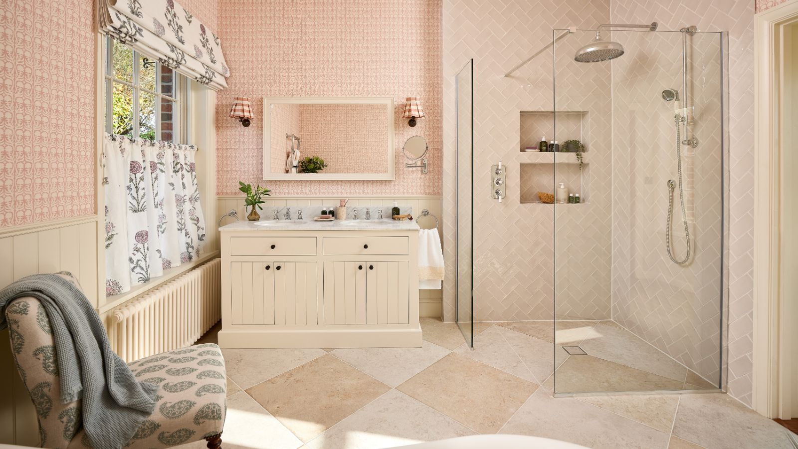 Light pink bathroom with walk-in glass shower and large stone floor tiles