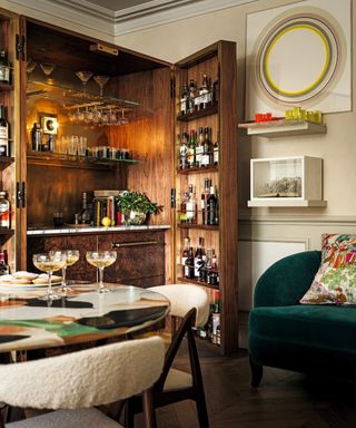 Wooden cabinet that opens in a home bar in a dining room