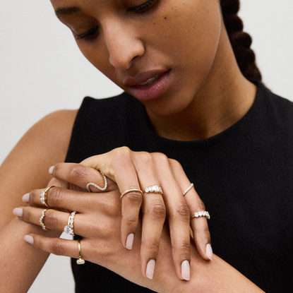 a woman wearing a stack of rings