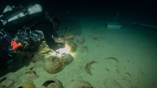 A scuba diver diving to the site of the wreck