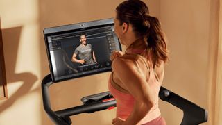 Woman running on Peloton Tread treadmill