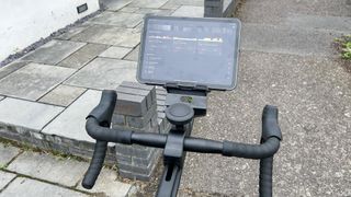 Wattbike Proton exercise bike handlebars with a tablet attached