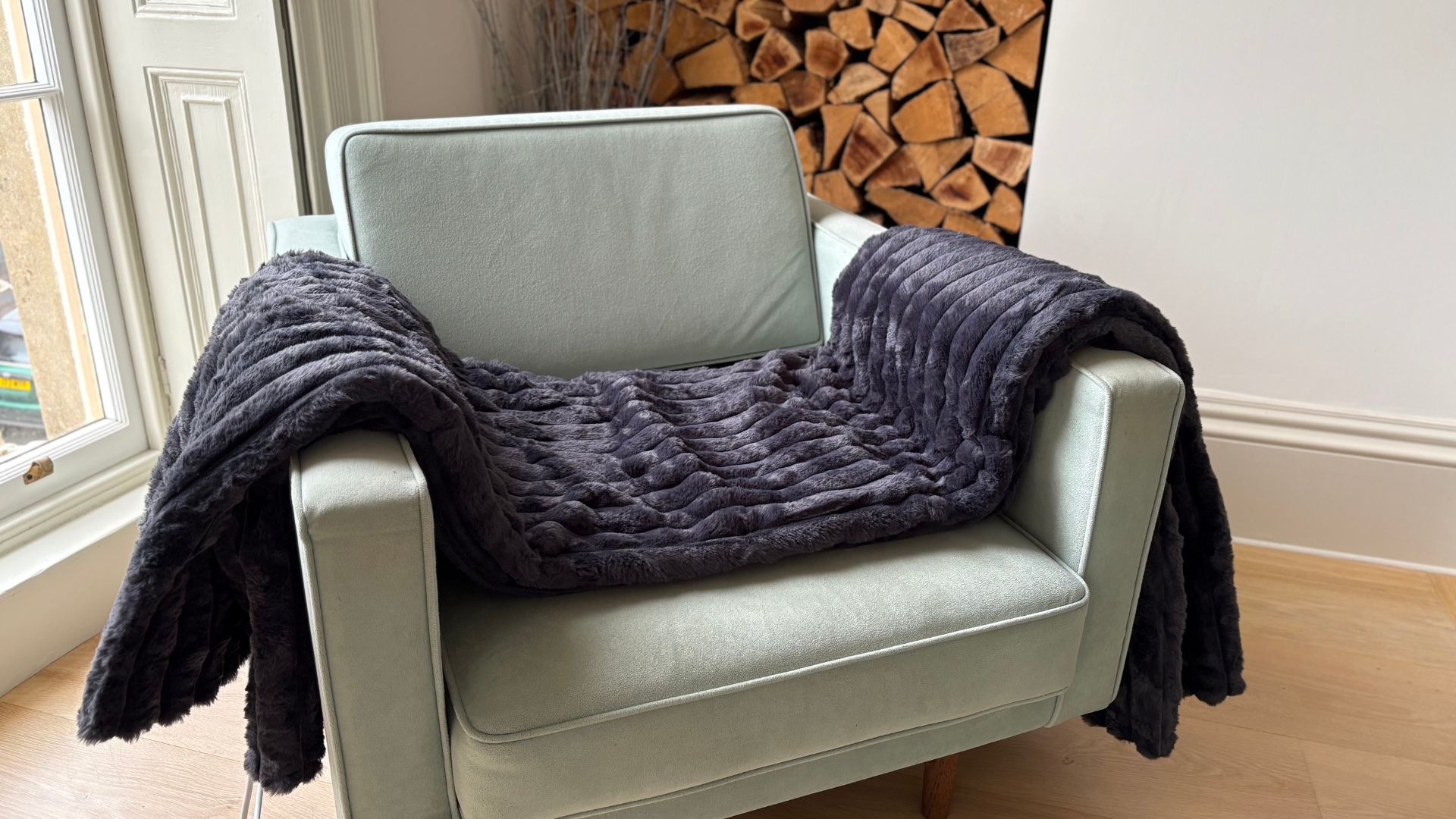 The Morphy Richards EverCosy Heated Throw on a chair, being tested for our review