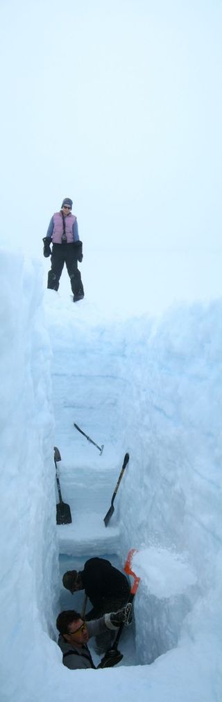 Researchers Christina Bell, Brad Danielson and, David Burgess digging a 4 meter (13 ft) snow pit to examine annual snow layers, Devon Island Ice Cap, Nunavut, Canada. From these layers, researchers are able to determine how much snow accumulates each year