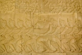 Bas relief carving showing Hindu devas, or gods, pulling on the snake Vasuki in the Churning of the Sea of Milk creation story.
