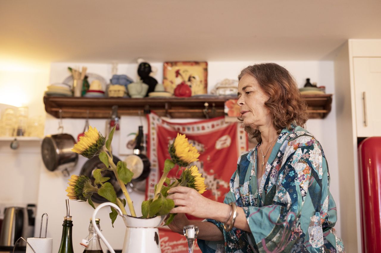 Woman looking at a bunch of sunflowers