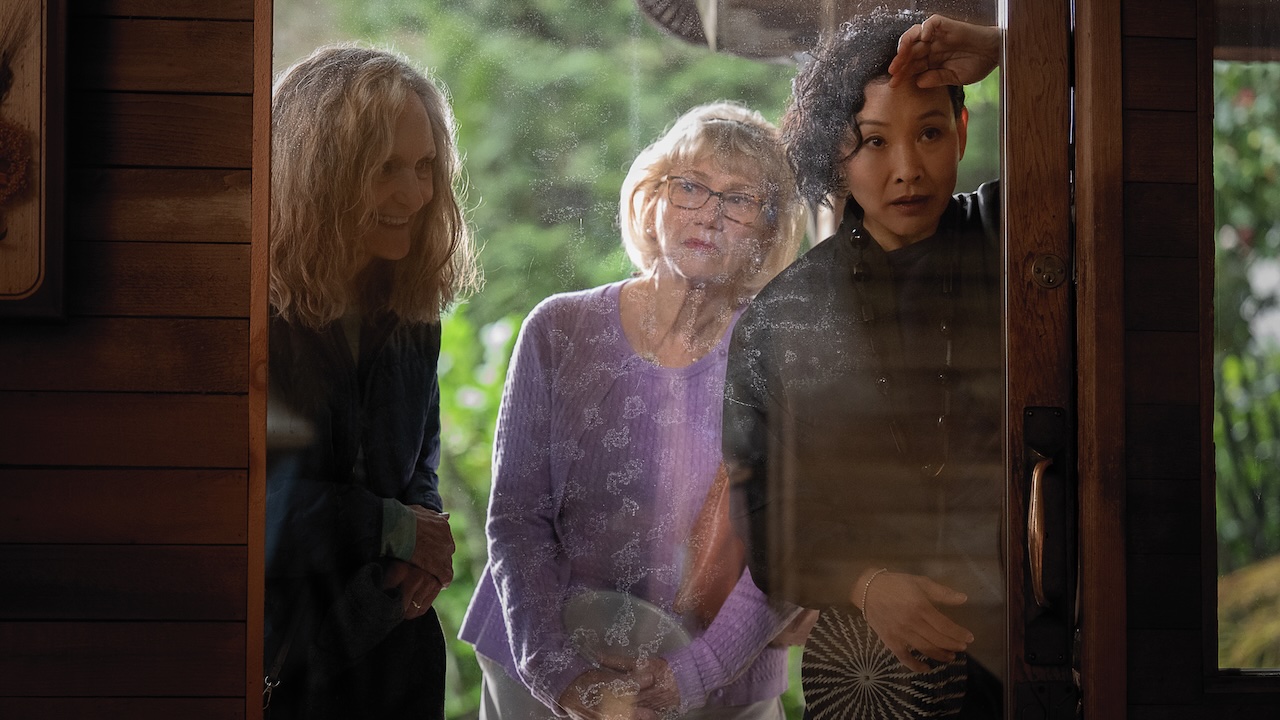 Beth Grant, Kathy Baker and Joan Chen standing outside a glass door looking in in Remarkably Bright Creatures