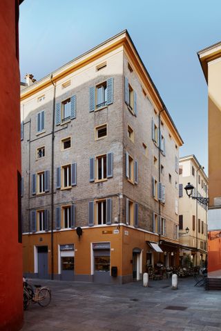 An exterior view of the Casa Mutina Modena four story building, which is located in the historical city center.