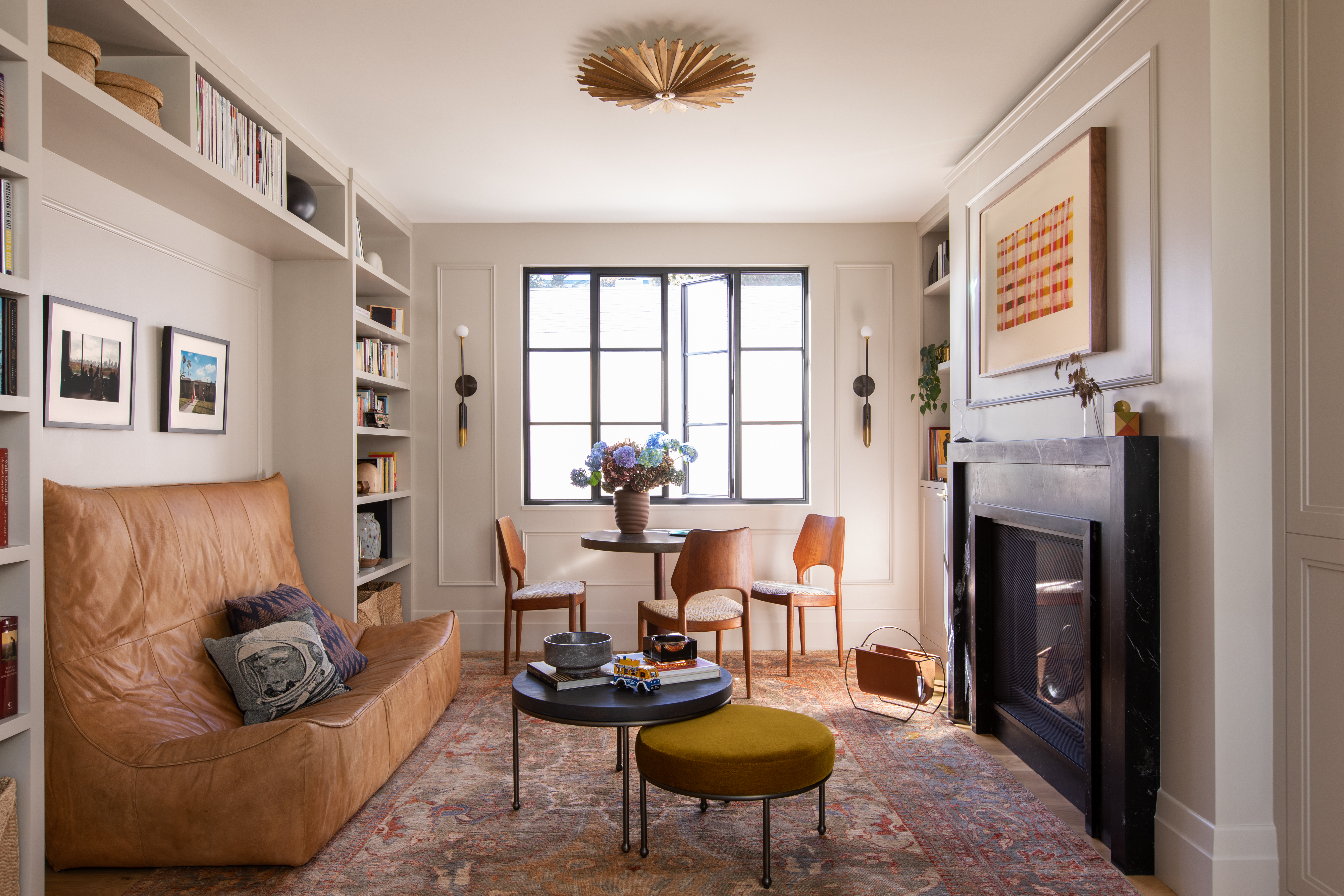 A compact living room with a fireplace as its centerpiece