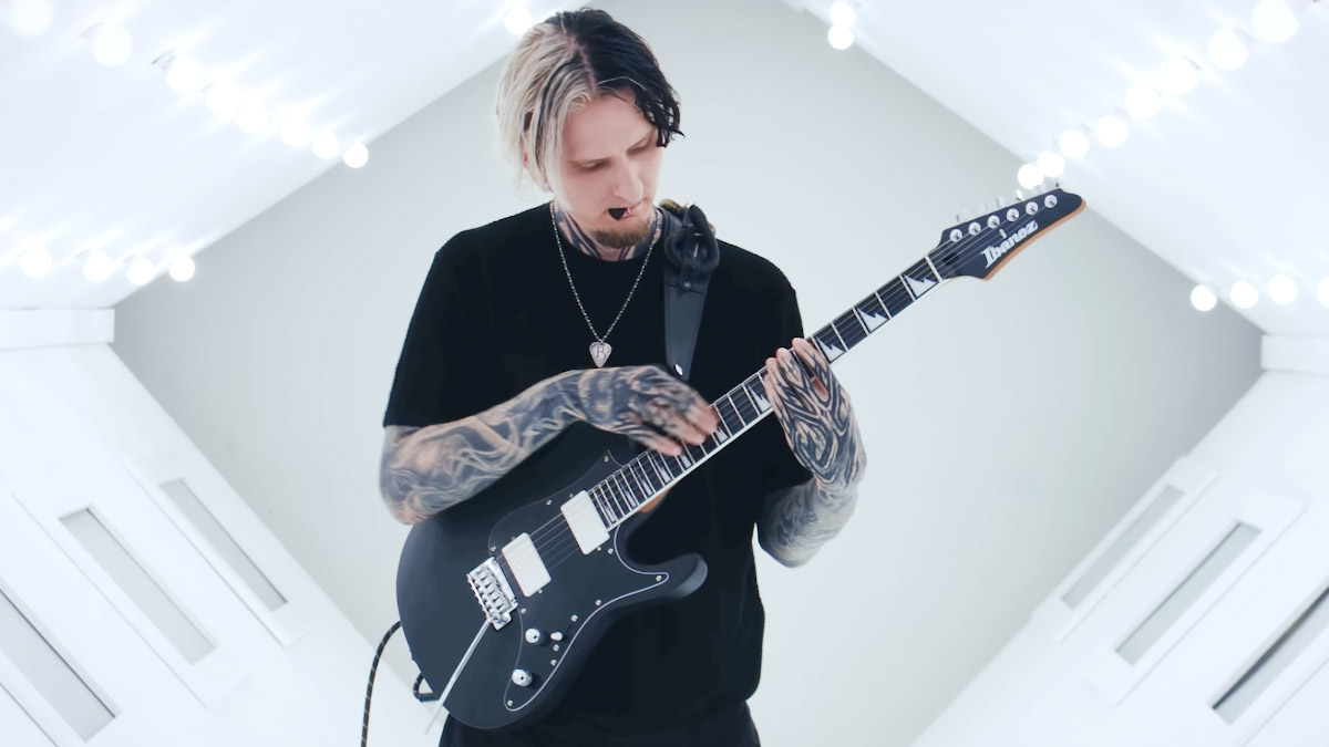 Bernth plays his new Ibanez BER10 signature guitar in what looks like the air-lock of a spacecraft.