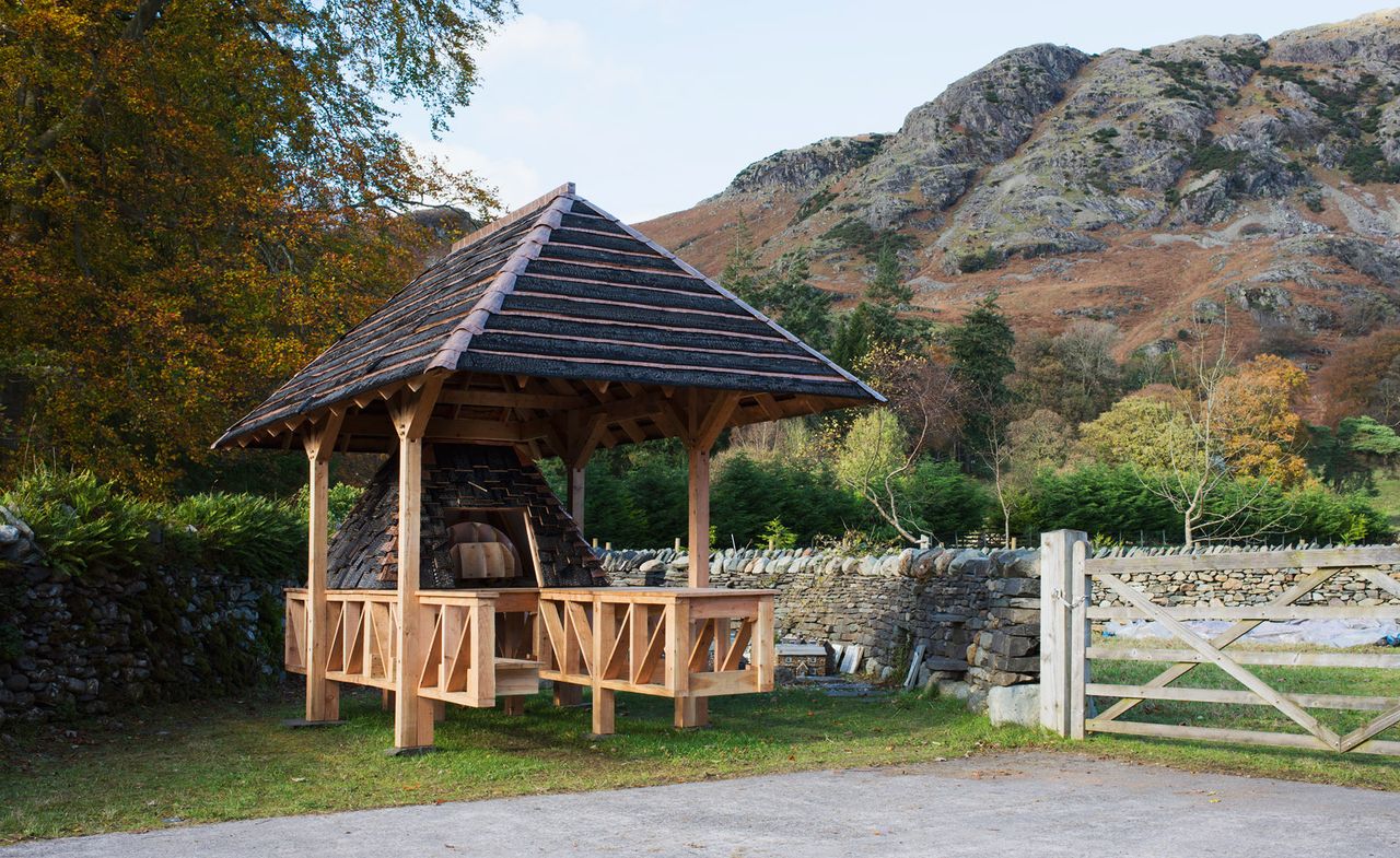 Outdoor wooden bread oven with roof to above