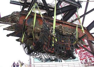 Still upside down, the engine is lifted from the Atlantic in 2001. It was built chiefly from wrought iron, cast iron and copper alloy.