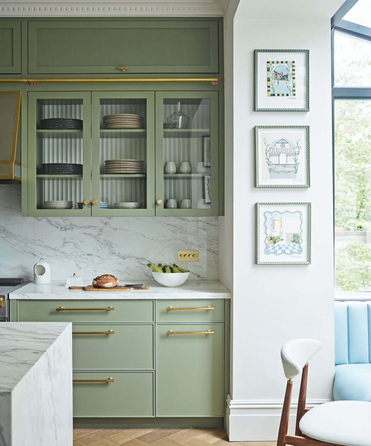 Green kitchen with glass-fronted cabinets, marble cabinets and worktops