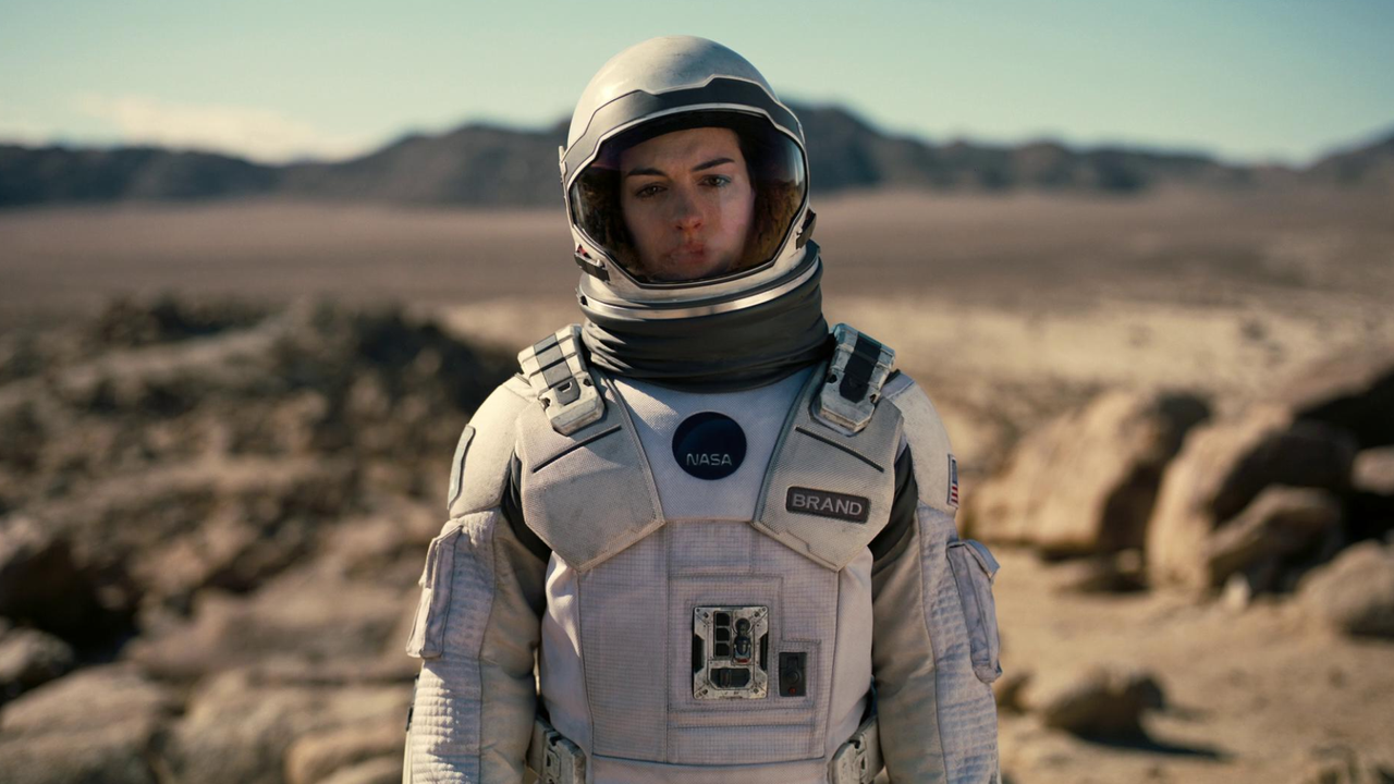 anne hathaway wears a space suit on a different planet in a still from interstellar