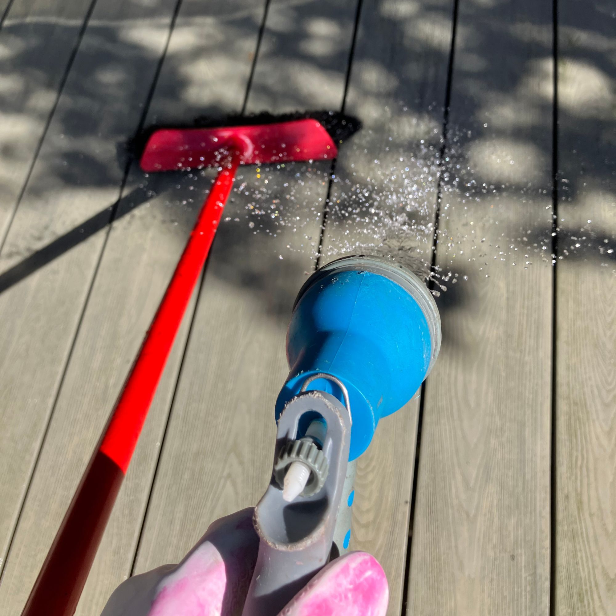 outdoor deck with garden hose and broom