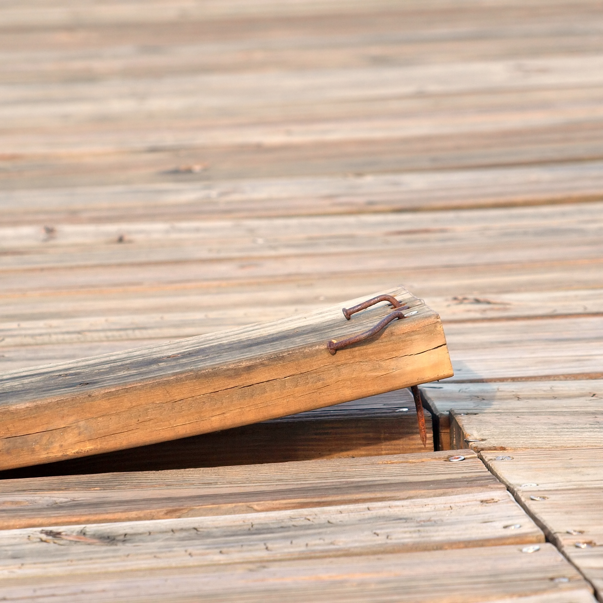 Deck board curling up with rusty nails
