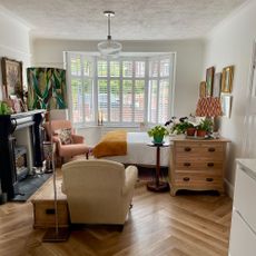 Living room transformed into bedroom area at bay window