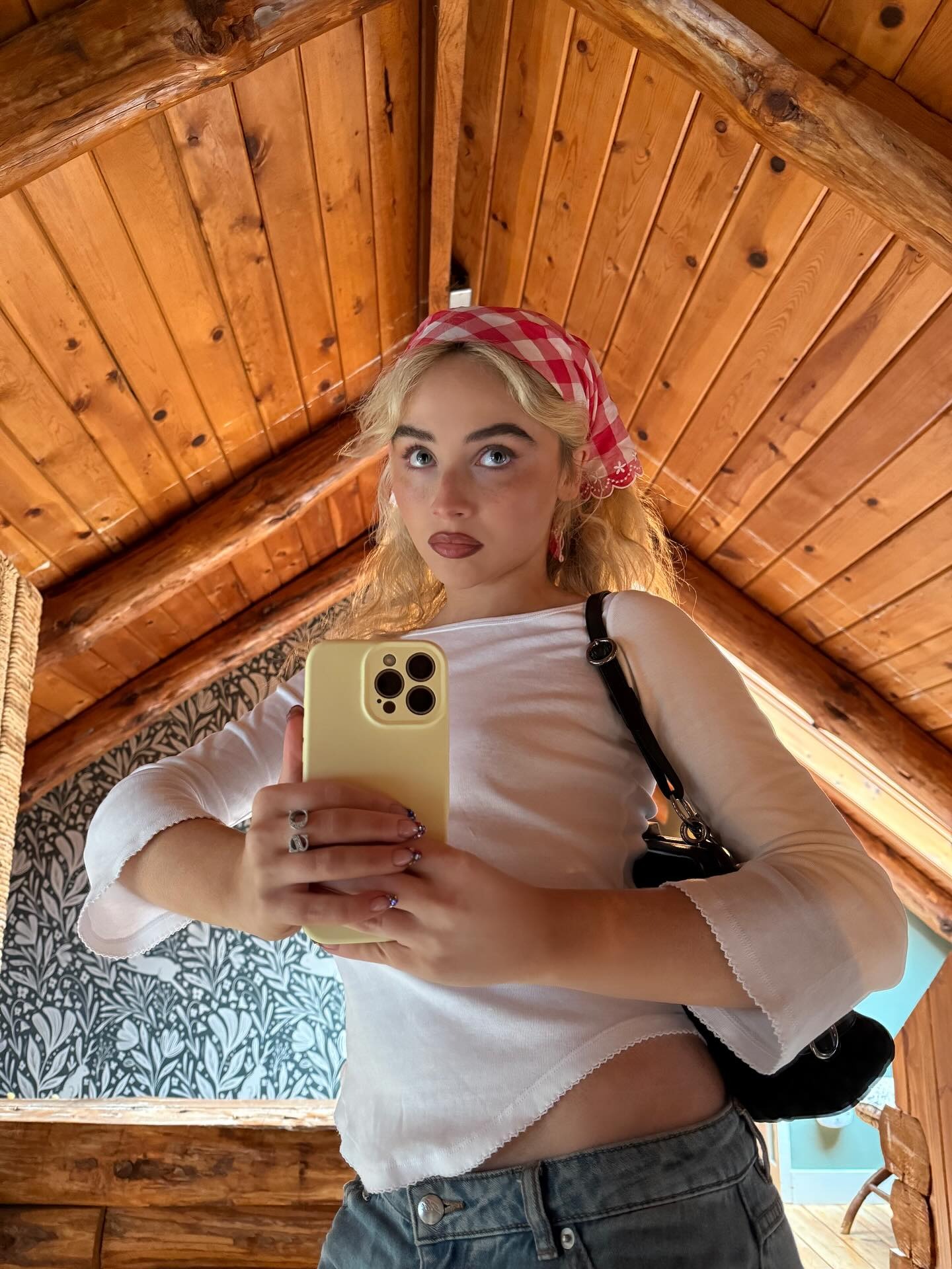 Sabrina Carpenter wears a white tee.