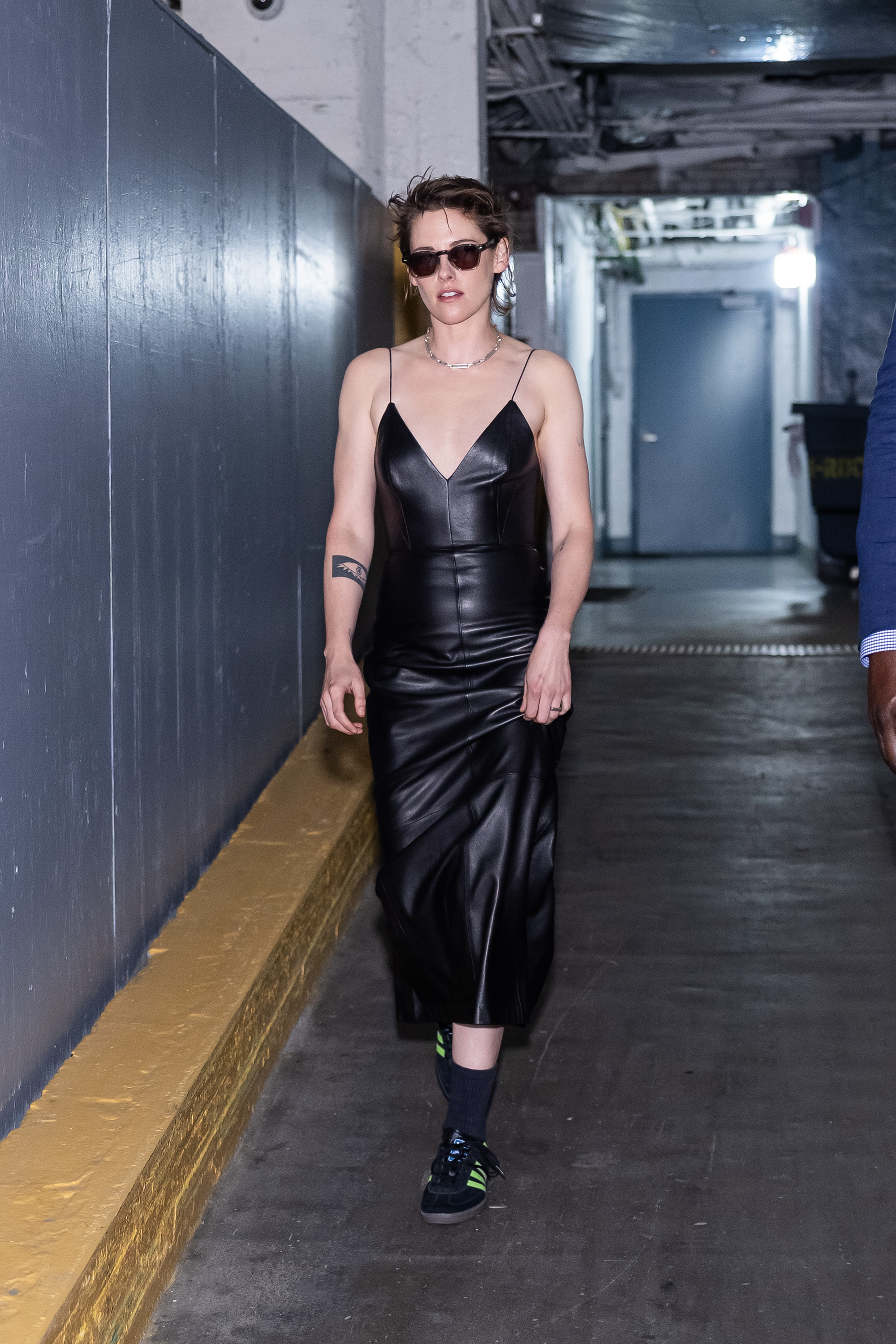 Kristen Stewart styled a leather slip dress with neon green Adidas Samba sneakers