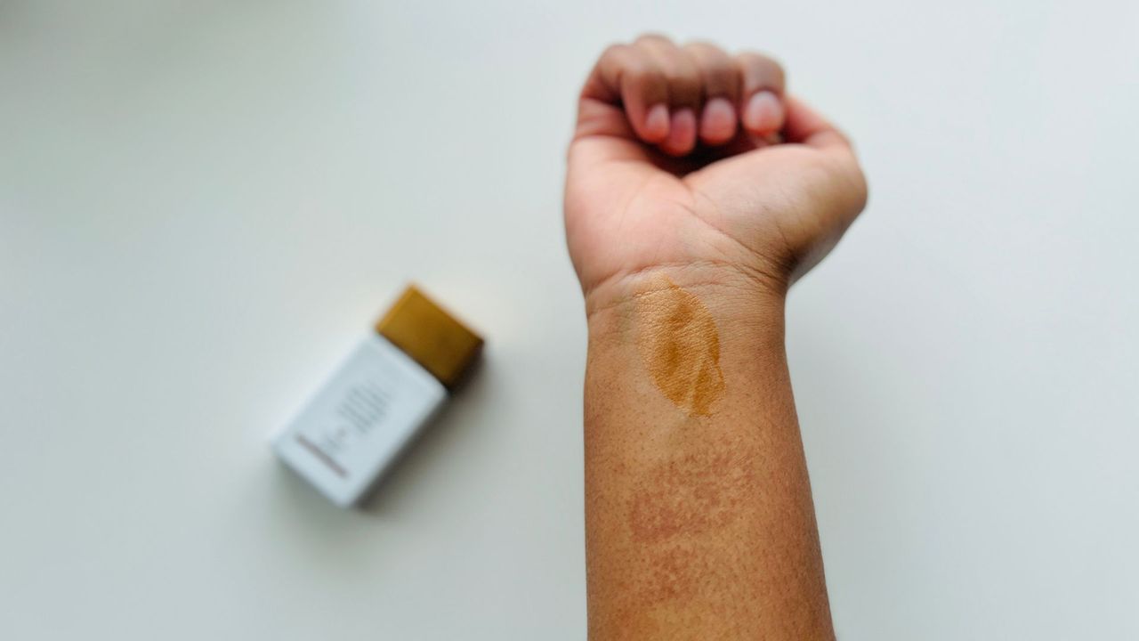 A swatch of the Drunk Elephant Bronzing Drops on a person's wrist, for w&amp;h's Drunk Elephant Bronzing Drops review.
