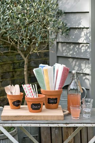 terracotta pots filled with garden party accessories