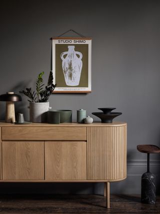 Grey wall with wooden sideboard