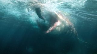 A swimmer tries to avoid the shark's gaping maw in "The Meg"