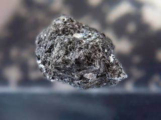 A moon rock brought back to Earth by Apollo 14. Many lunar samples were previously dated to 3.9 billion years ago, but one new study suggests that their radioactive ages could have been "reset" by giant planet migration.