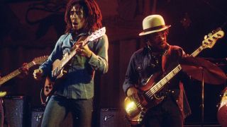 Bob Marley and Aston 'Family Man' Barrett performing on stage (Photo by Ian Dickson/Redferns)