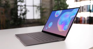 Samsung Galaxy Book S laptop on a white surface against a blurred background
